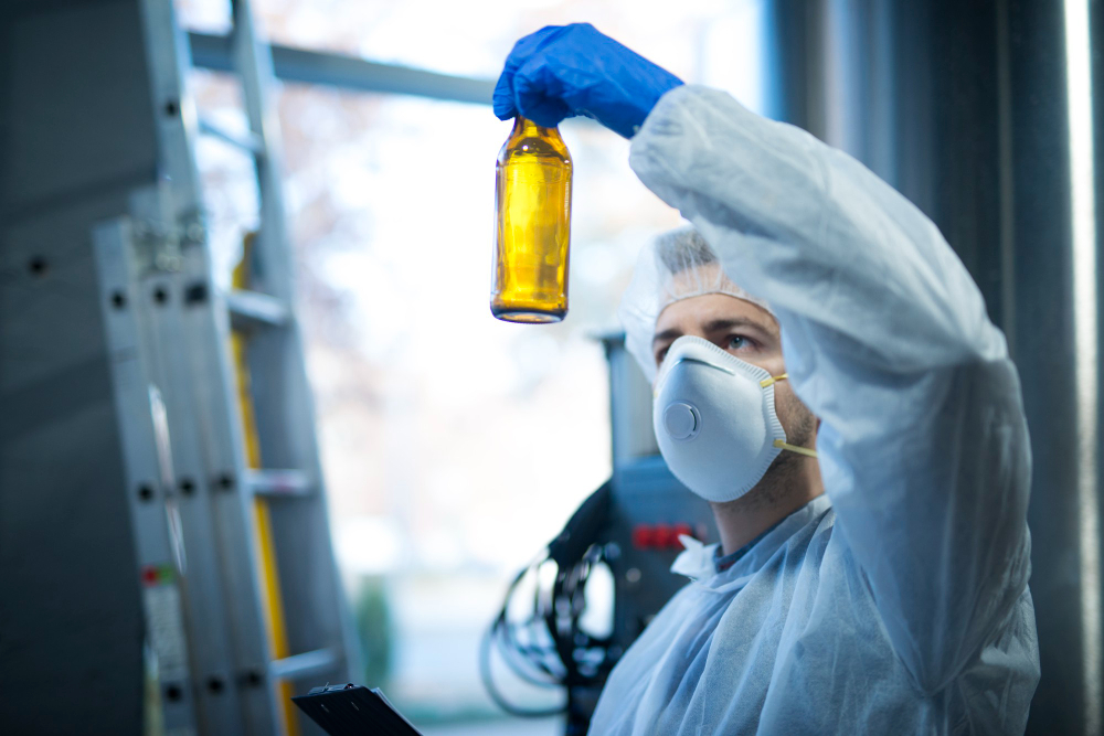 Scientist in protective gear holding an amber chemical bottle, representing Southern Cross Chemicals’ commitment to reliable chemical supply in Tulsa, Oklahoma.